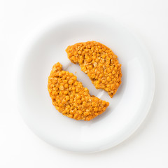 One Cracked Grain Cookie on White Round Dish