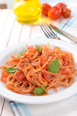 Pasta with tomato sauce on plate on table close-up