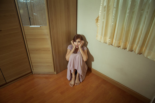 Scared Abused Woman Sitting In The Corner