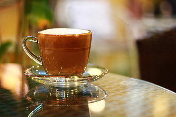 coffee cup with colorful lights in the background