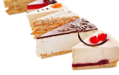 Assortment of pieces of cake, isolated on white © Africa Studio