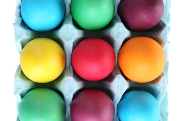 Colorful Easter eggs in tray close up