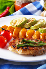 Grilled steak, grilled vegetables and fried potato pieces