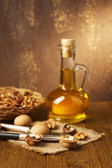 Obraz na płótnie Canvas Walnut oil and nuts on wooden table