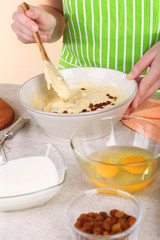 Woman preparing Easter cake in kitchen