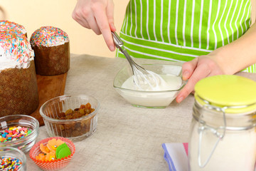 Woman preparing Easter cake in kitchen