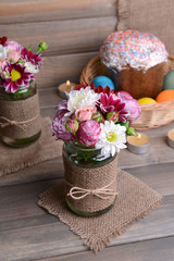 Beautiful bouquet of bright flowers in jars
