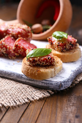 Composition with knife,  tasty sandwiches with salami sausage,