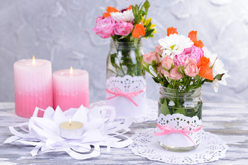 Beautiful bouquet of bright flowers in jars