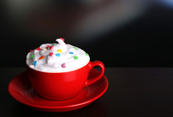 Cup of strong coffee with cream and candies