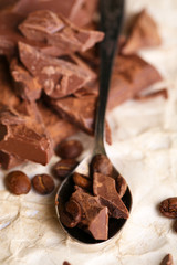Chopped bar of chocolate on light background