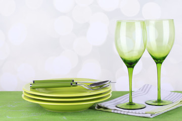 Green table settings, on table, on light background