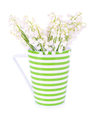 Beautiful lilies of the valley in cup, isolated on white
