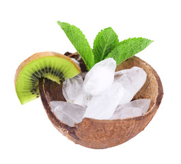 Fruit slices and ice cubes in coconut shell isolated