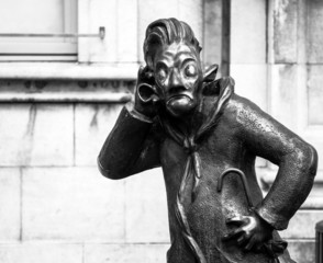 Funny bronze statue of man in Namur