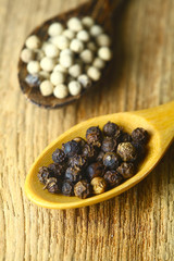 close up of the white pepper and black pepper.