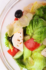 Greek salad with onion, tomato, cucumbers and cheese