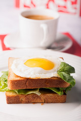 Breakfast: fried egg on the white bread and coffee