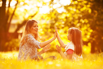 Mother and daughter relaxing in park.