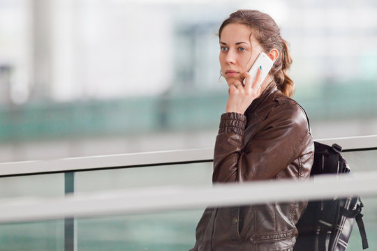 Woman talking on the phone at the airport