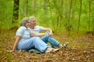 Elderly couple sit