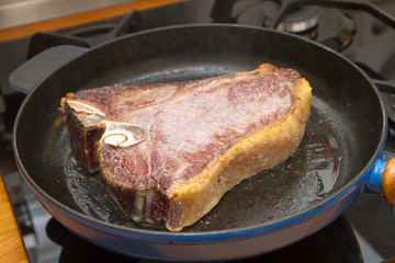 t-bone steak in a pan