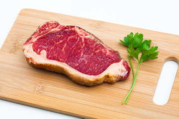 fresh marbled meat on a wooden hardboard