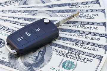 Car keys over dollar banknotes