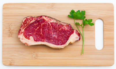 fresh marbled meat on a wooden hardboard