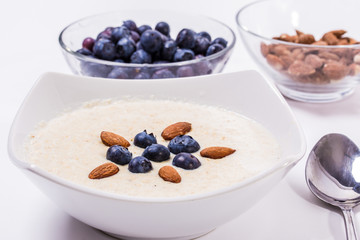 Bowl of oatmeal porridge with walnuts  and blueberry