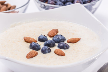 Bowl of oatmeal porridge with walnuts  and blueberry