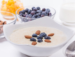 Bowl of oatmeal porridge with walnuts  and blueberry