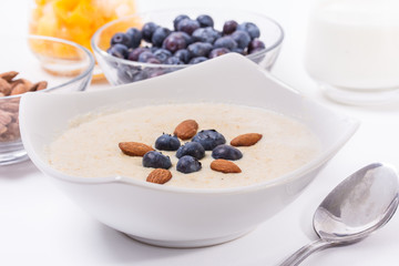 Bowl of oatmeal porridge with walnuts  and blueberry
