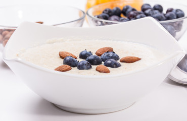 Bowl of oatmeal porridge with walnuts  and blueberry