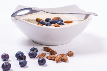 Bowl of oatmeal porridge with walnuts  and blueberry