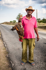 cuban man sells live rooster - 64877160