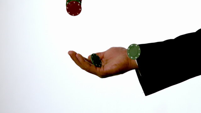 Man in suit catching casino chips