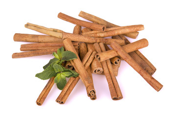 cinnamon sticks and mint leaf on a white background