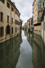 Obraz na płótnie Canvas Traditional Buildings on a Canal in an Old Italian Town