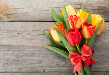Fresh colorful tulips with ribbon and bow