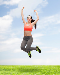 sporty teenage girl jumping in sportswear