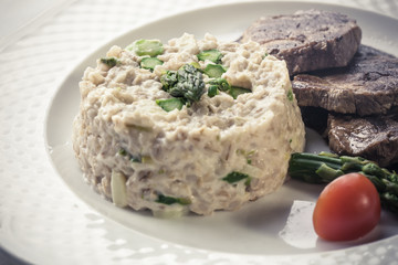 Medallions of pork tenderloin served with asparagus risotto .