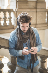 young handsome man listening to music with headphones