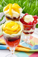 Layer fruit desserts on wooden tray. Summer garden party