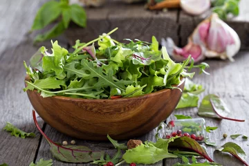Foto auf Glas Green salad leaves in a wooden bowl © fahrwasser