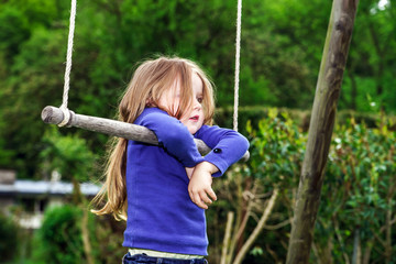 Cute little girl swinging on seesaw