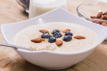 Bowl of oatmeal porridge with walnuts  and blueberry