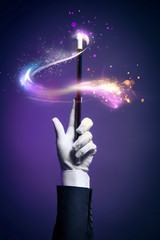 High contrast image of magician hand with magic wand - 64886743