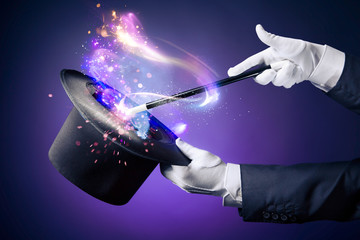 High contrast image of magician hand with magic wand - 64886772