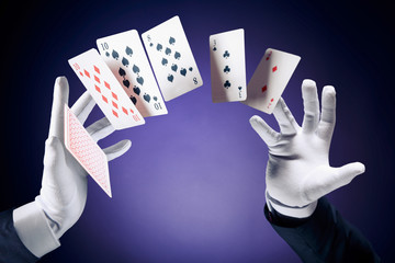 High contrast image of magician making card tricks